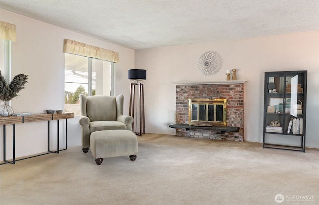 sitting room with carpet flooring, a fireplace, and a textured ceiling