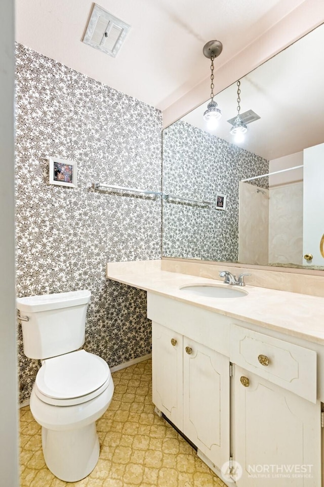 full bathroom with vanity, a shower with shower curtain, toilet, and beam ceiling