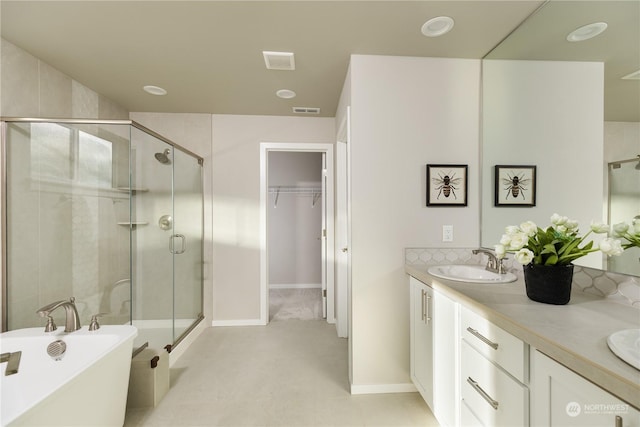 bathroom with independent shower and bath and vanity