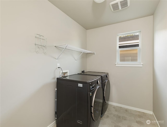 laundry room with independent washer and dryer