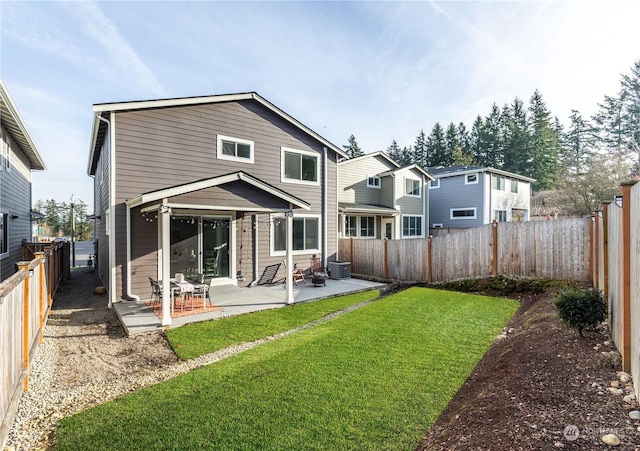 back of property with a patio, a yard, and central air condition unit