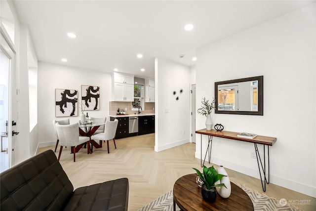 living room with light parquet floors and sink