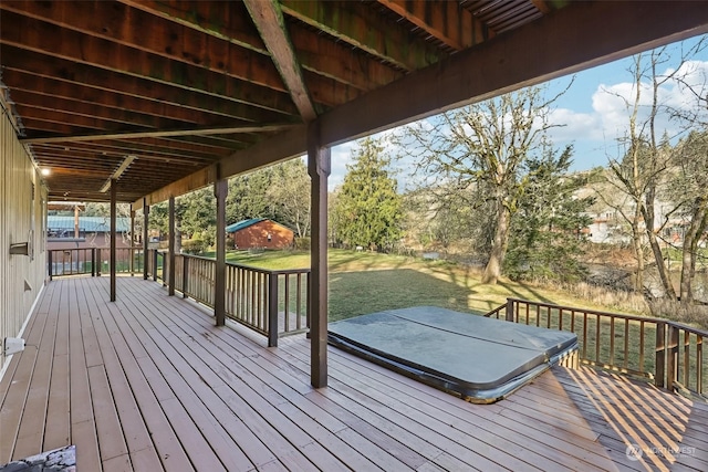 wooden terrace with a yard and a covered hot tub