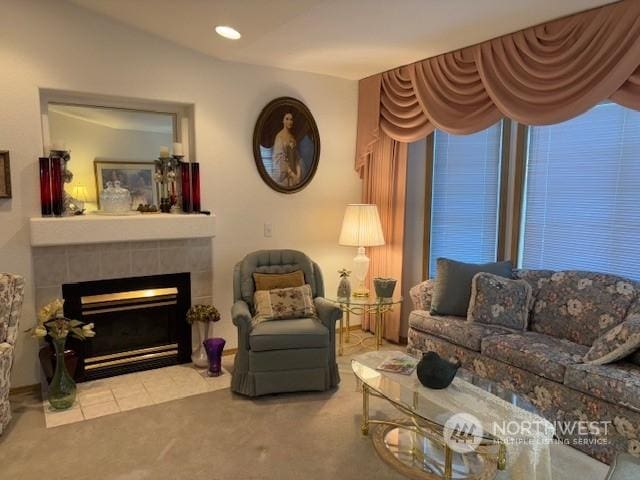 living room with light colored carpet and a tile fireplace