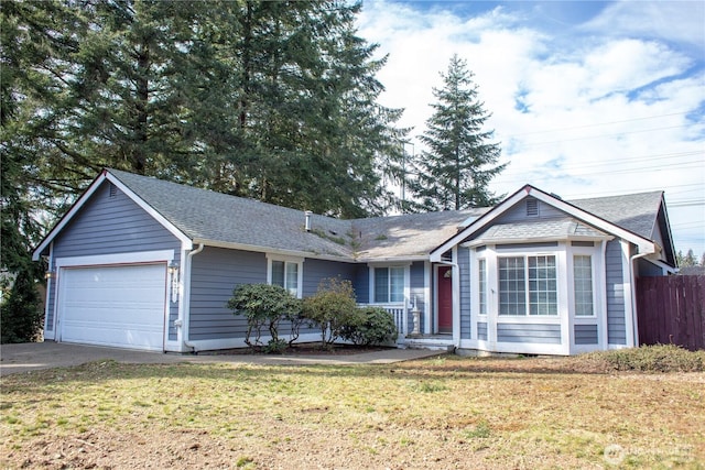 ranch-style home with a shingled roof, a front yard, fence, a garage, and driveway