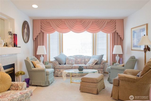 carpeted living room with a tiled fireplace and recessed lighting