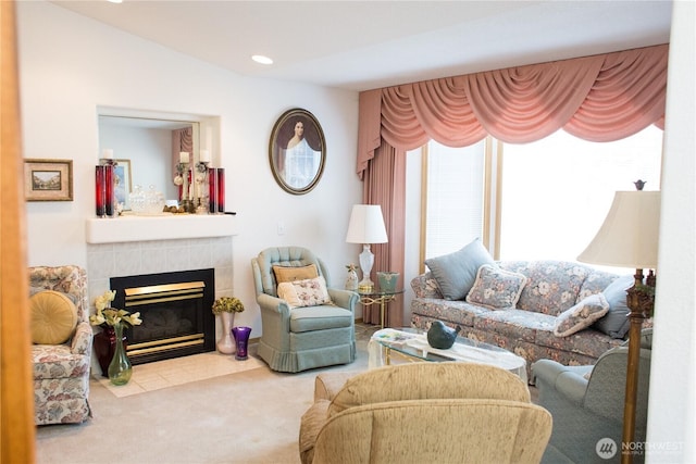 living room featuring carpet floors, recessed lighting, and a tile fireplace