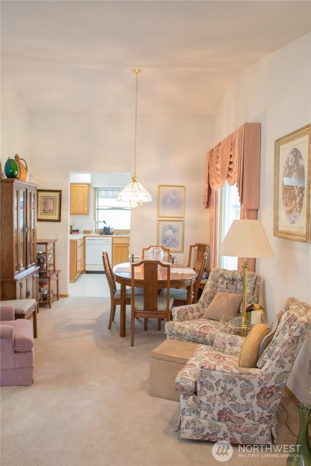 living room with light carpet, lofted ceiling, and a healthy amount of sunlight