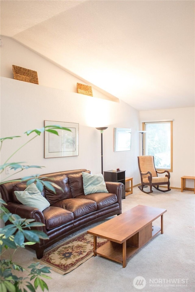 living area with vaulted ceiling and light carpet