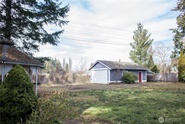 view of yard featuring an outbuilding and fence