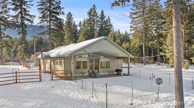 view of snow covered rear of property