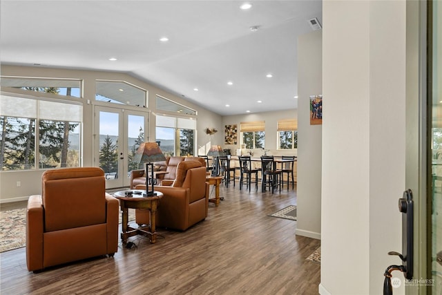 living room with wood-type flooring, lofted ceiling, and french doors