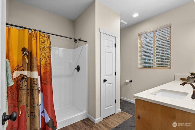 bathroom featuring vanity, hardwood / wood-style floors, and a shower with shower curtain