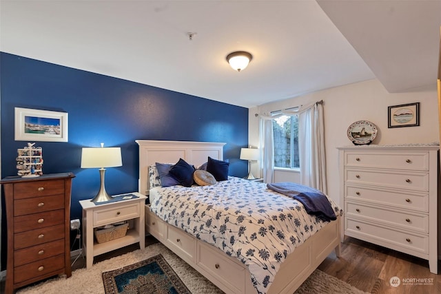 bedroom with dark hardwood / wood-style flooring