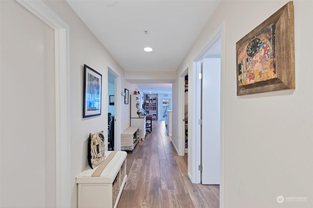 corridor with hardwood / wood-style floors