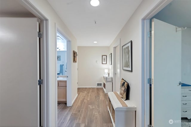 corridor with light hardwood / wood-style flooring