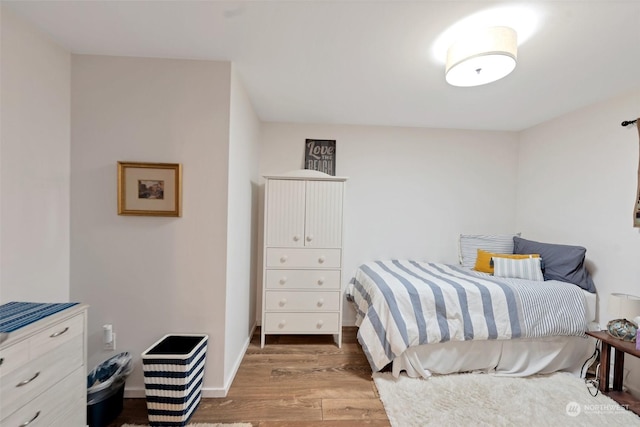 bedroom with hardwood / wood-style floors