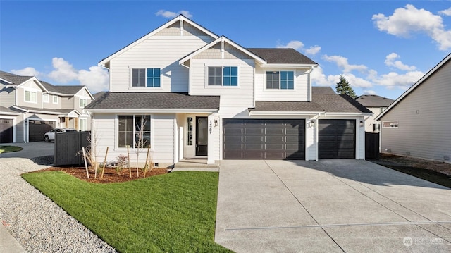 view of front of house featuring a garage and a front lawn