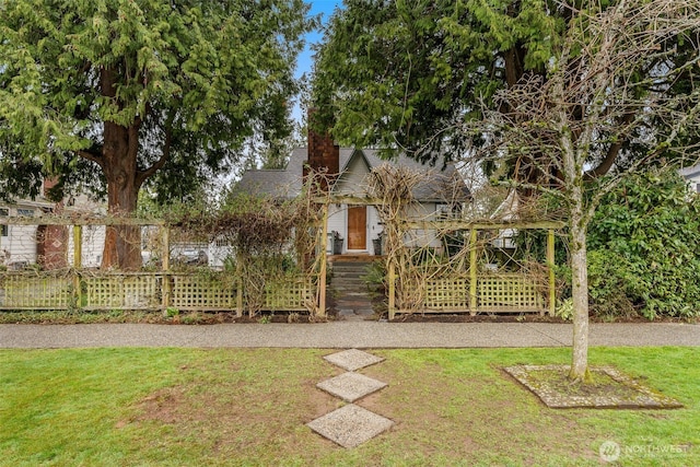 view of front of property featuring a front lawn and a chimney