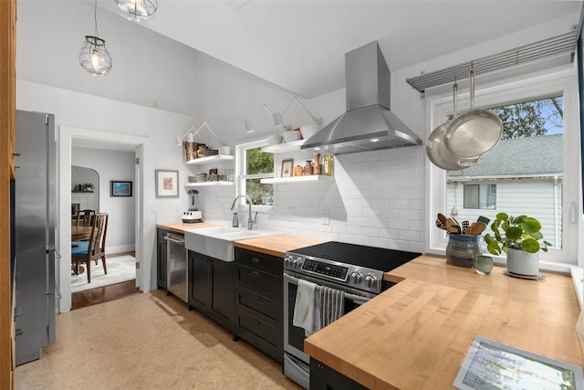 kitchen featuring a sink, butcher block countertops, island exhaust hood, stainless steel appliances, and open shelves