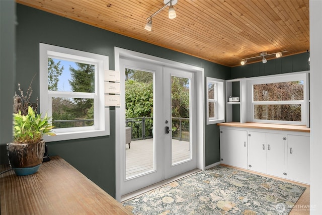 doorway to outside with wood ceiling, french doors, a healthy amount of sunlight, and rail lighting