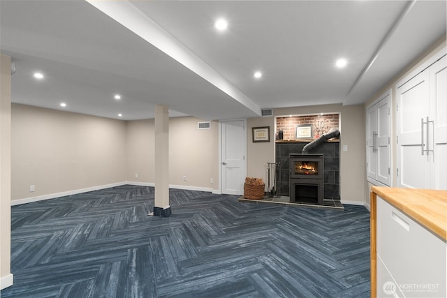 finished basement with visible vents, recessed lighting, and baseboards