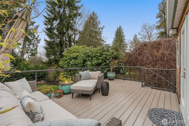 wooden terrace with an outdoor living space