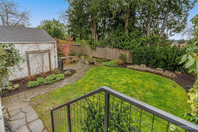 view of yard featuring fence private yard and an outdoor structure