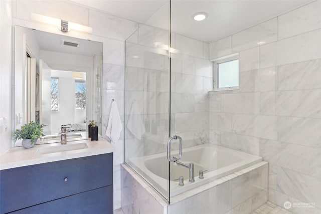 bathroom featuring separate shower and tub and vanity