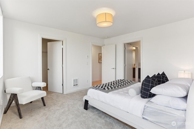 carpeted bedroom featuring connected bathroom