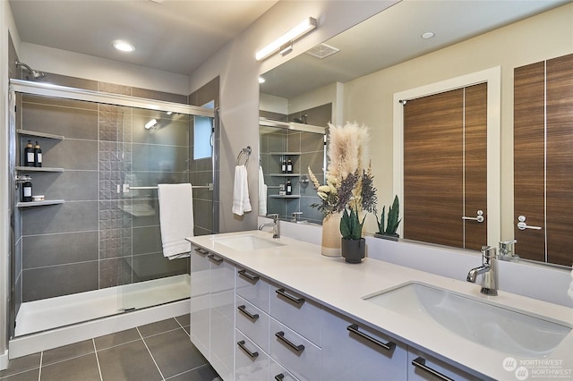 bathroom with tile patterned flooring, vanity, and an enclosed shower