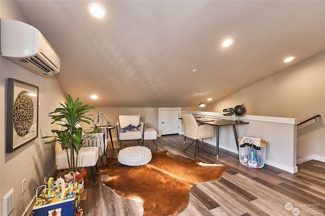 office area with a wall mounted air conditioner, dark wood-type flooring, and vaulted ceiling