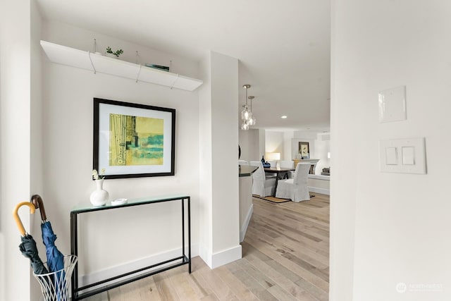 corridor with light hardwood / wood-style floors