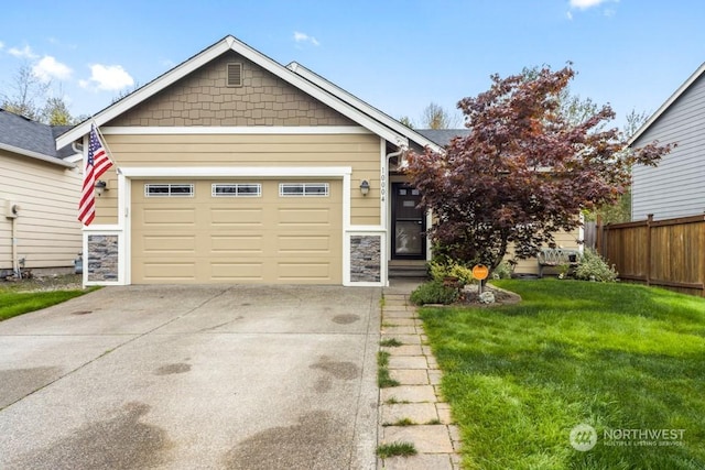 view of front of home featuring a garage and a front yard