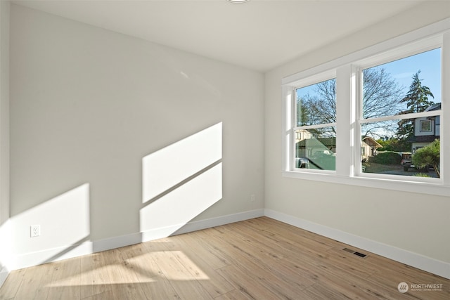 spare room with light hardwood / wood-style floors