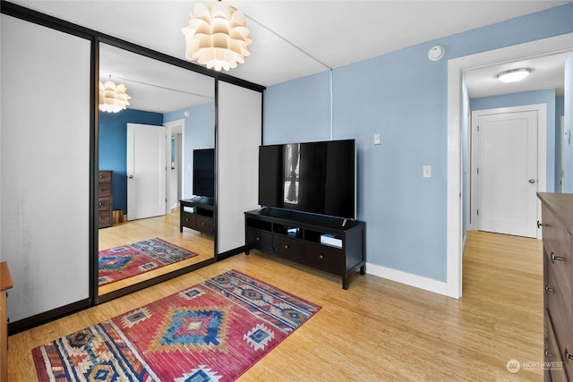 living room with light hardwood / wood-style flooring and a chandelier