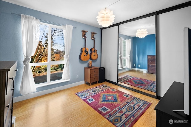 interior space with an inviting chandelier and hardwood / wood-style floors