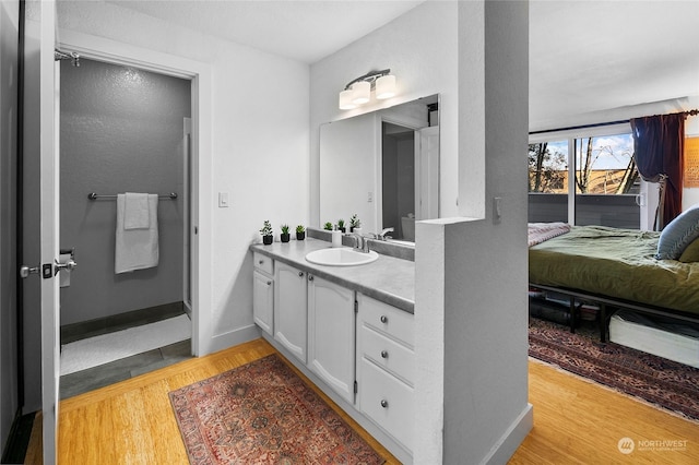 bathroom featuring hardwood / wood-style flooring and vanity