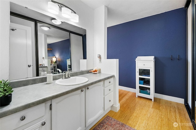 bathroom with hardwood / wood-style flooring and vanity