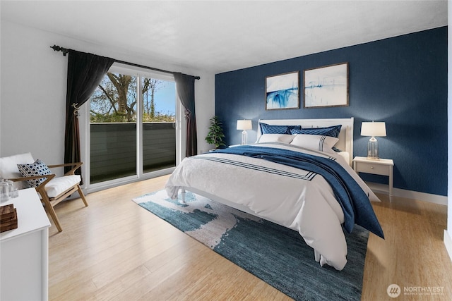 bedroom featuring light wood-type flooring, access to outside, and baseboards