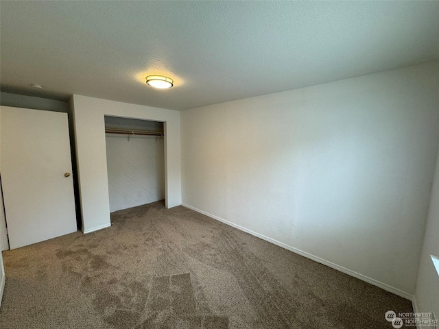 unfurnished bedroom featuring a closet, a textured ceiling, and carpet flooring