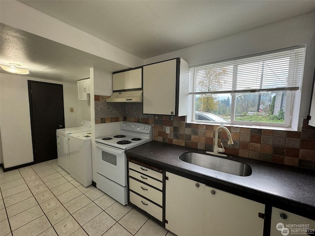 kitchen featuring sink, tasteful backsplash, washing machine and clothes dryer, white cabinets, and white electric stove