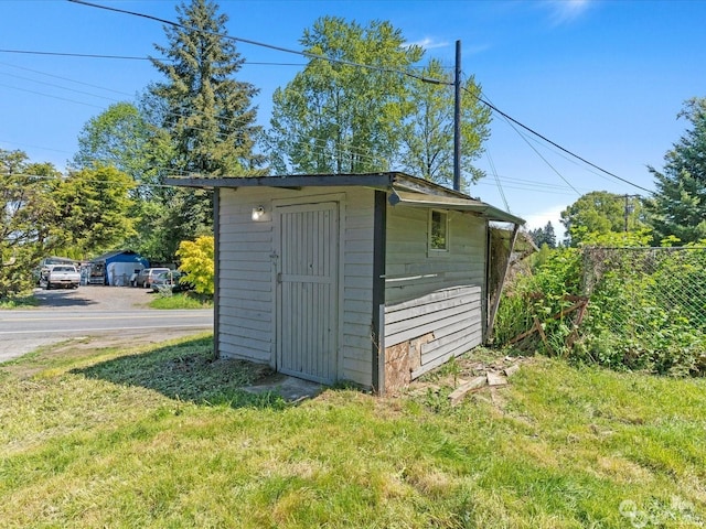 view of outbuilding with a lawn