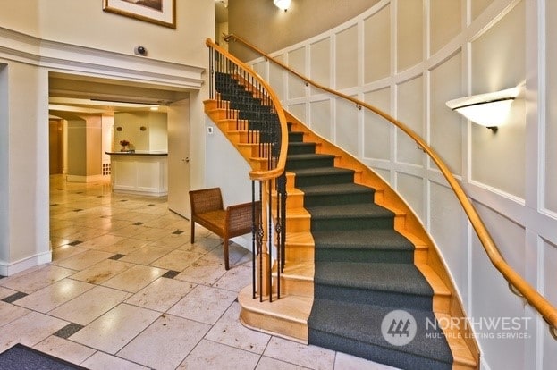 staircase featuring a towering ceiling