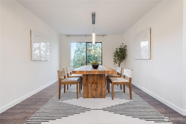 dining area with dark hardwood / wood-style flooring