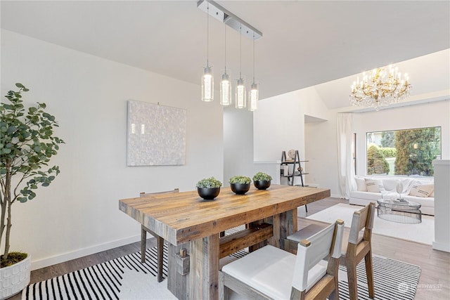 dining room with wood-type flooring and a chandelier