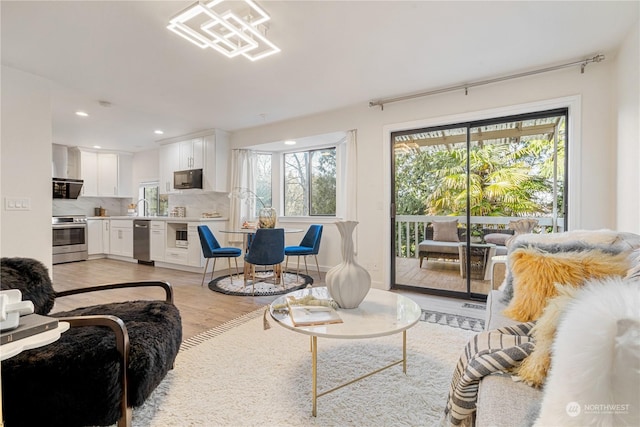 living room with sink and light hardwood / wood-style floors