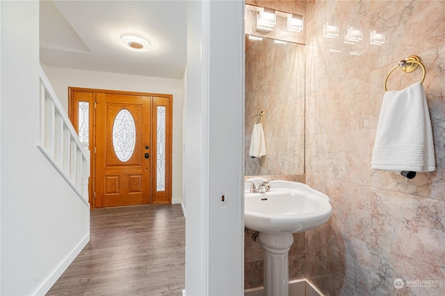 bathroom featuring tile walls and hardwood / wood-style floors