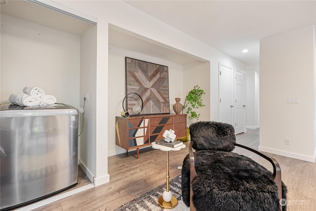 living area featuring light wood-type flooring and washer / clothes dryer