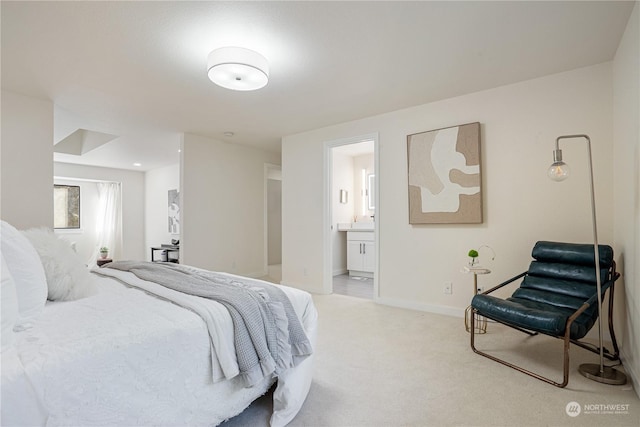 bedroom featuring light carpet and ensuite bath